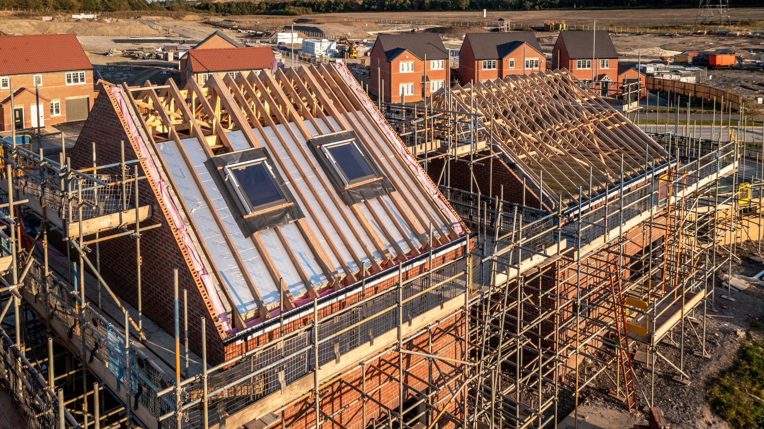 Aerial view of a roof under construction with attic room and sky